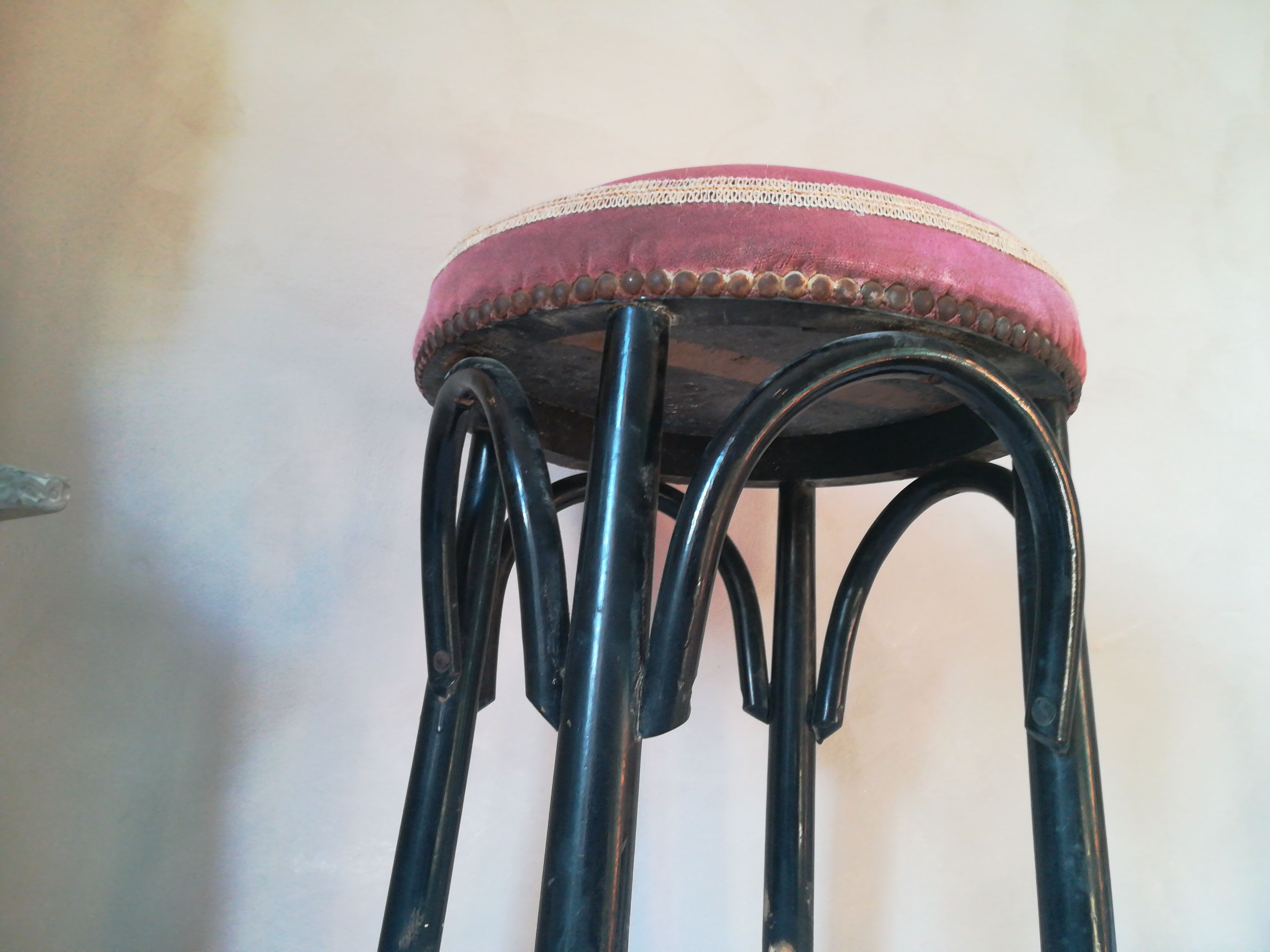 Black stool sitting in velvet rose