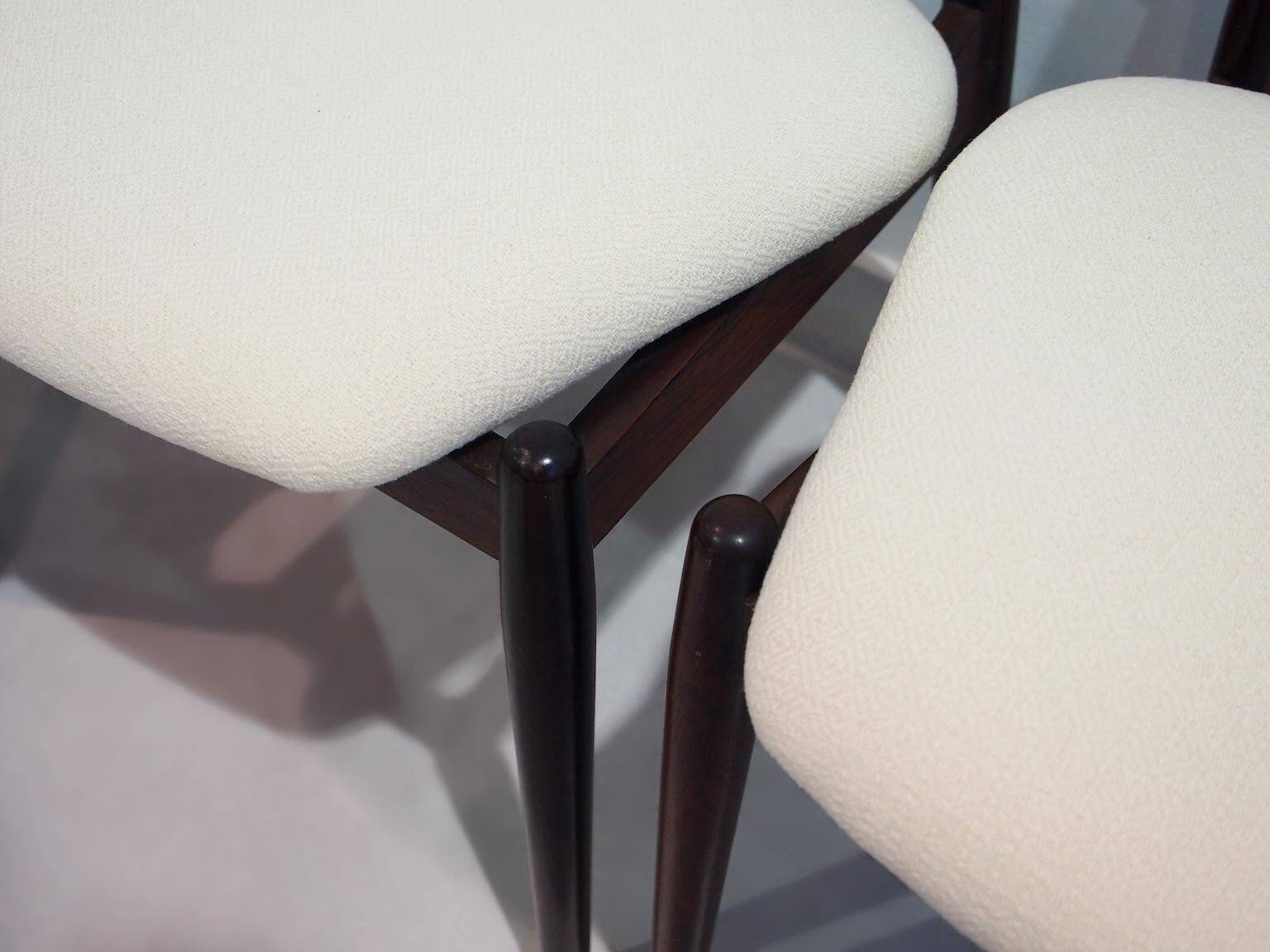 Set of six hardwood chairs by Arne Vodder for Sibast with white textile upholstery.