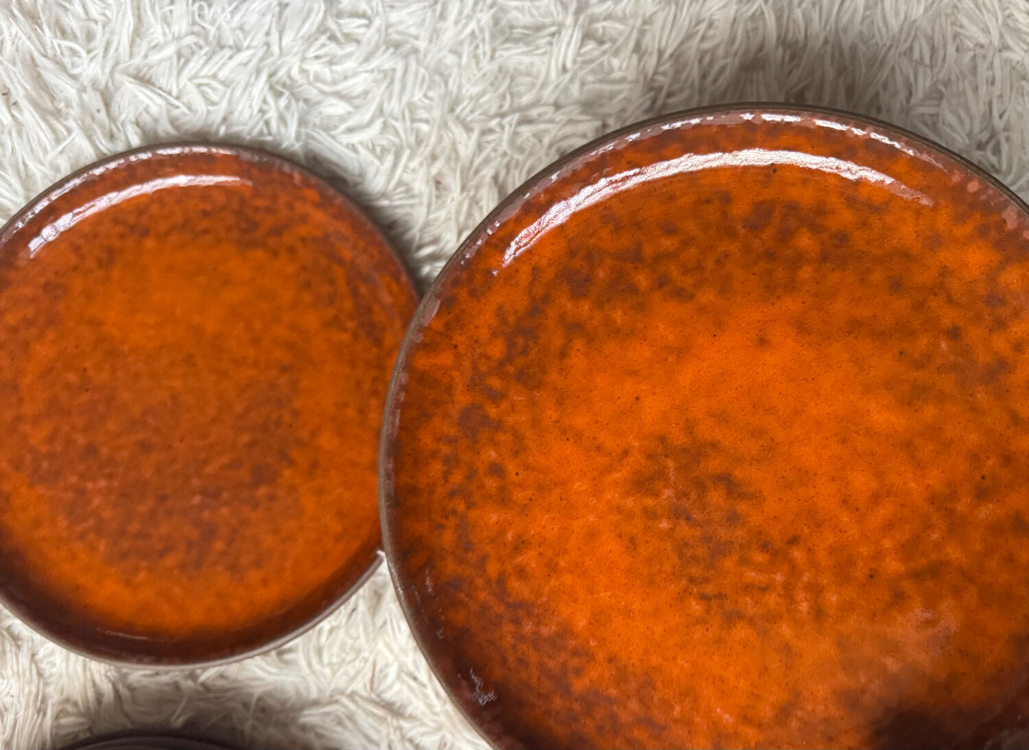 Orange glazed ceramic plates from the 1970s