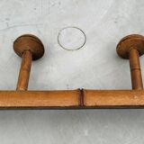 Old rustic wooden coat rack turned in imitation of bamboo