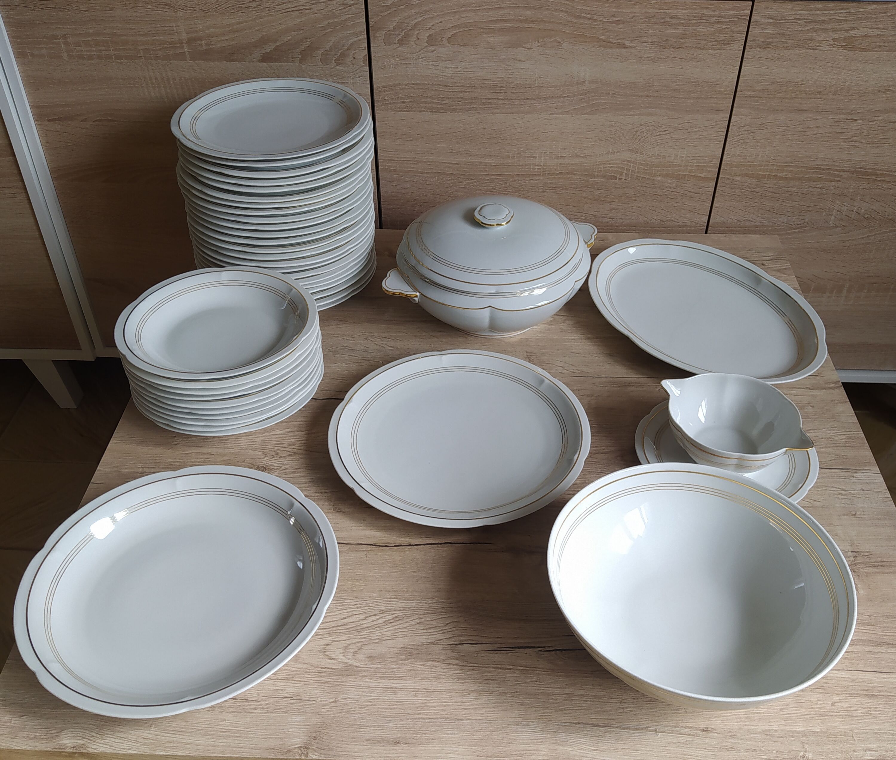 White Limoges porcelain table service with gold trim.