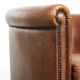 Sheepskin club armchair with a cognac colour finished with decorative nails