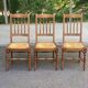 Solid wood chair with a straw seat and carved bar backrest.