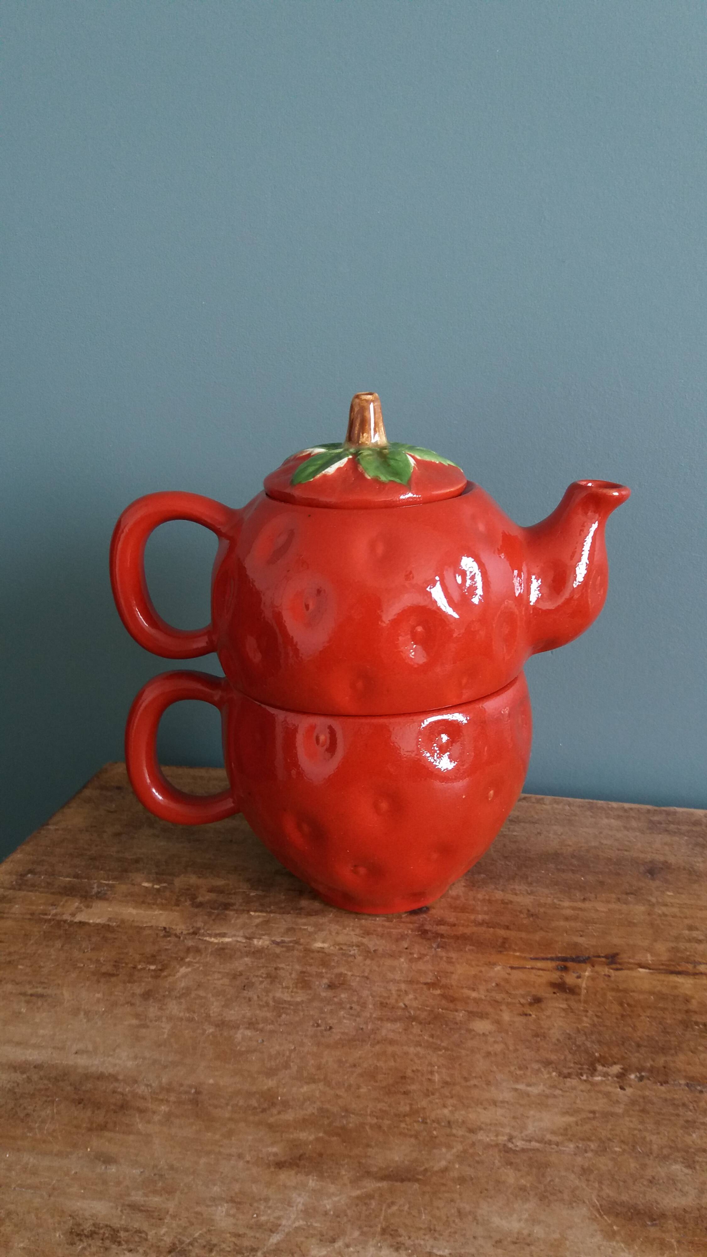 Teapot and cup in the shape of a strawberry.
