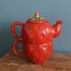 Teapot and cup in the shape of a strawberry.