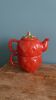 Teapot and cup in the shape of a strawberry.