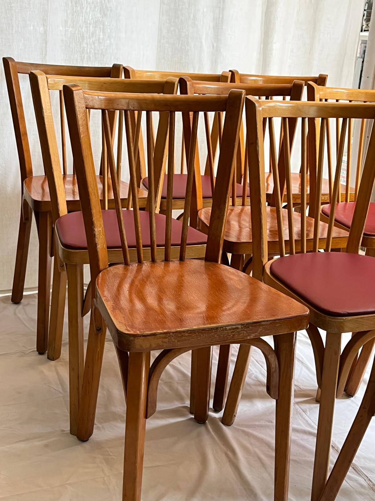 Set of Baumann bistro chairs with a mix of wooden seat and faux leather.