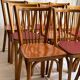 Set of Baumann bistro chairs with a mix of wooden seat and faux leather.