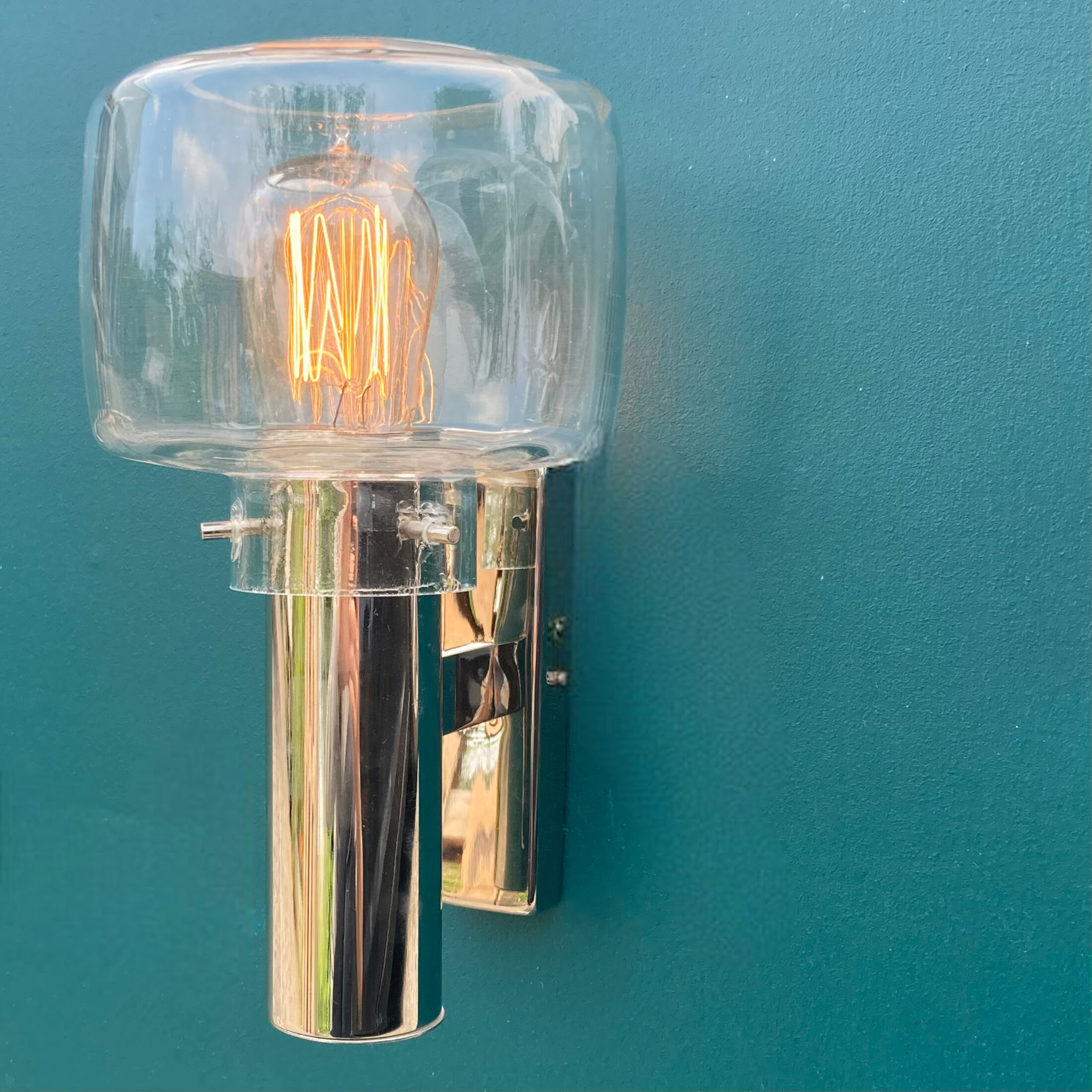 Wall lamp in stainless steel and globe in transparent glass