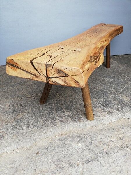 Big bench in solid rough wood very thick Brutalism