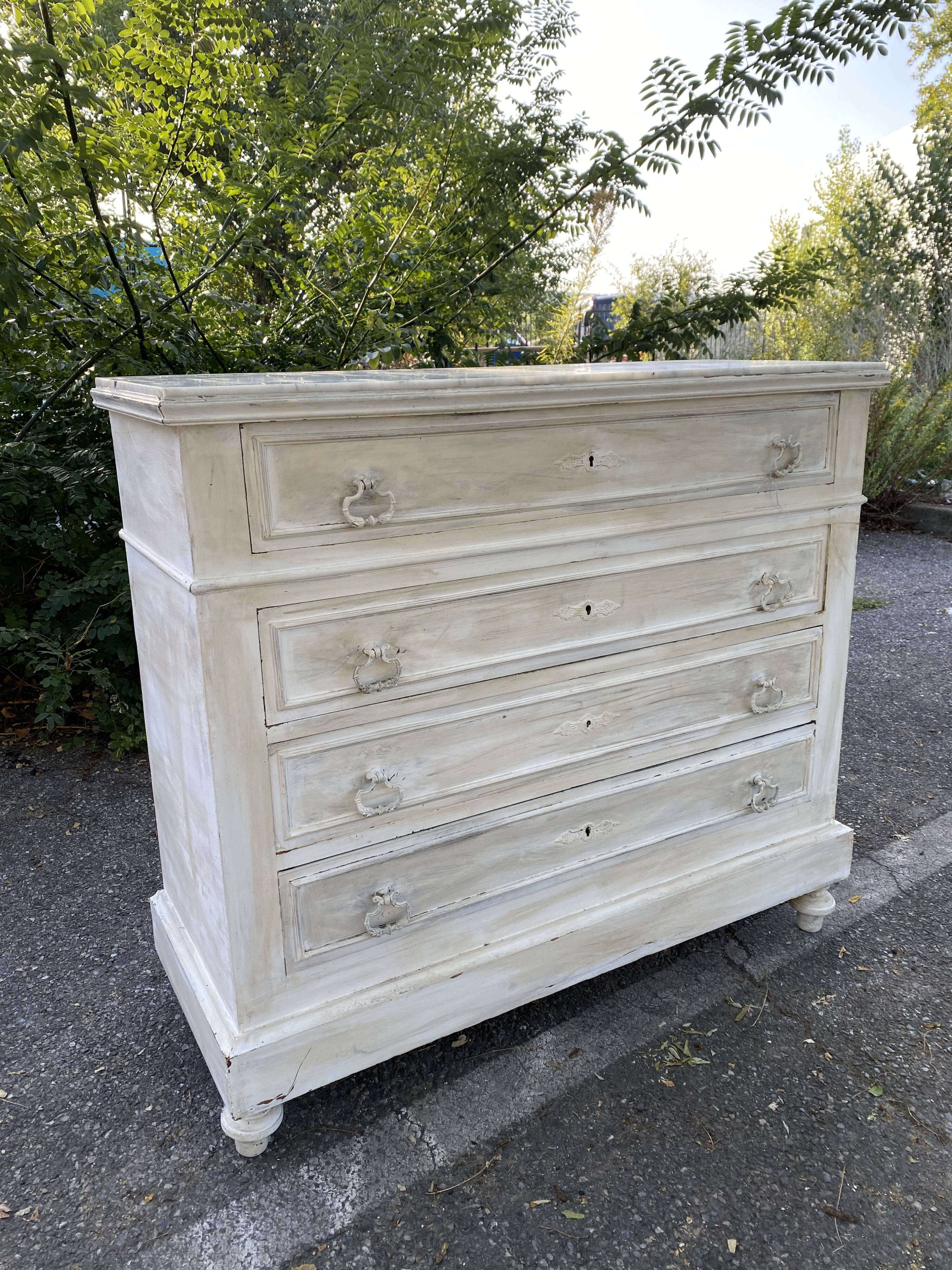 Old chest of drawers in bleached wood with white marble top