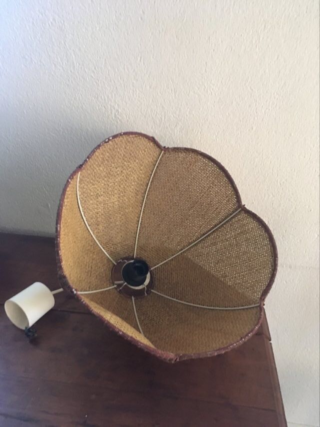 Two-tone flower hanging in braided straw.