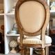 Medallion back chair in moulded wood and beige fabric.