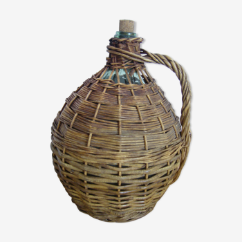 Demijohn dressed in wicker with handle