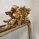 Antique mirror with a gilded frame and cherubs.