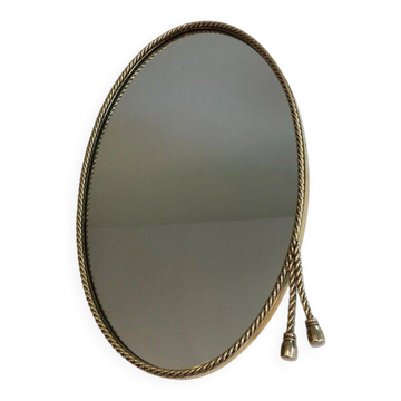 Miroir ovale entouré d'une cordelette en laiton