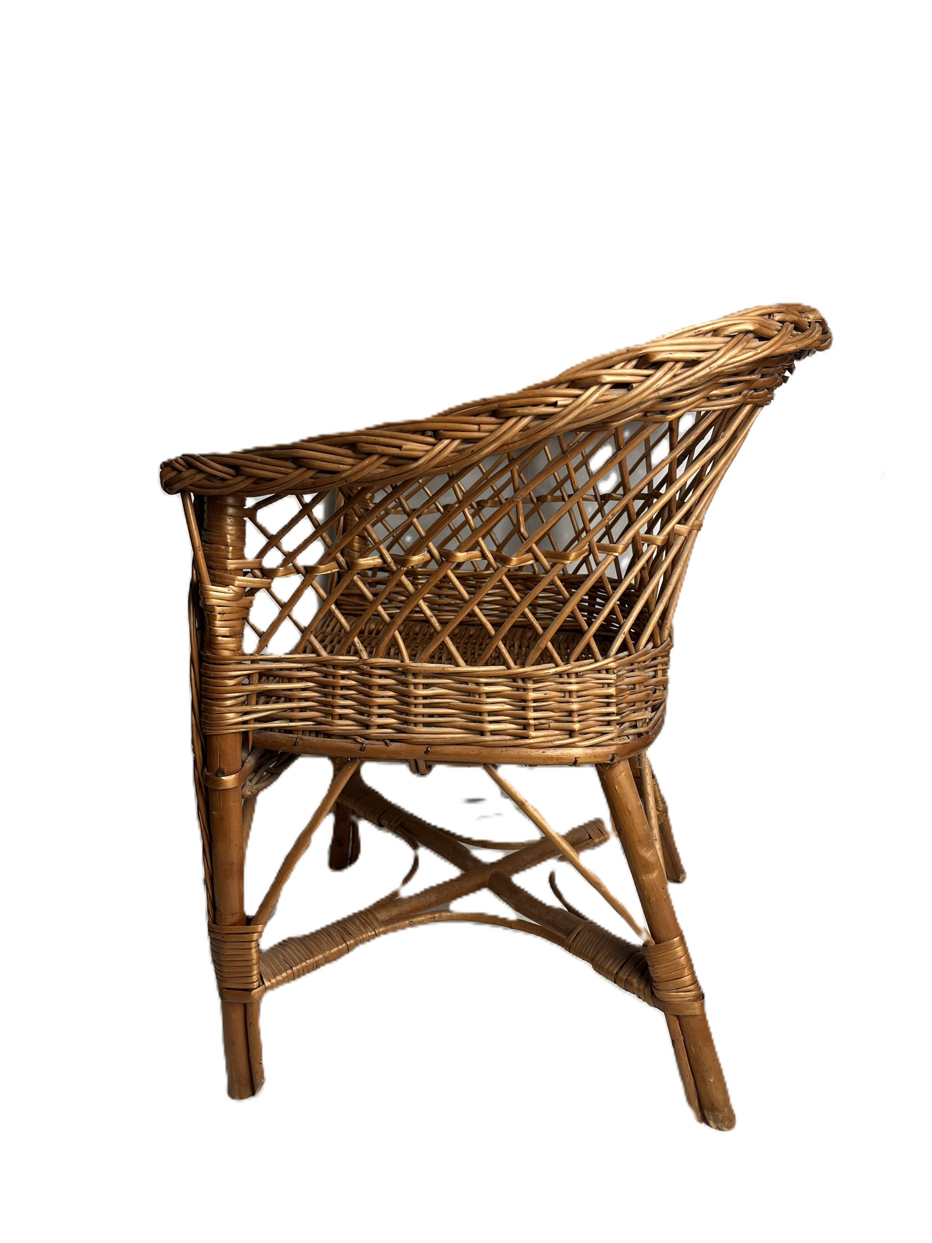 Vintage, children's armchair in woven rattan from around 1970.