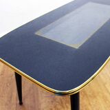 Low table with compass feet with decorative cabinet