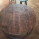 Large round coffee table in wood and wrought iron.