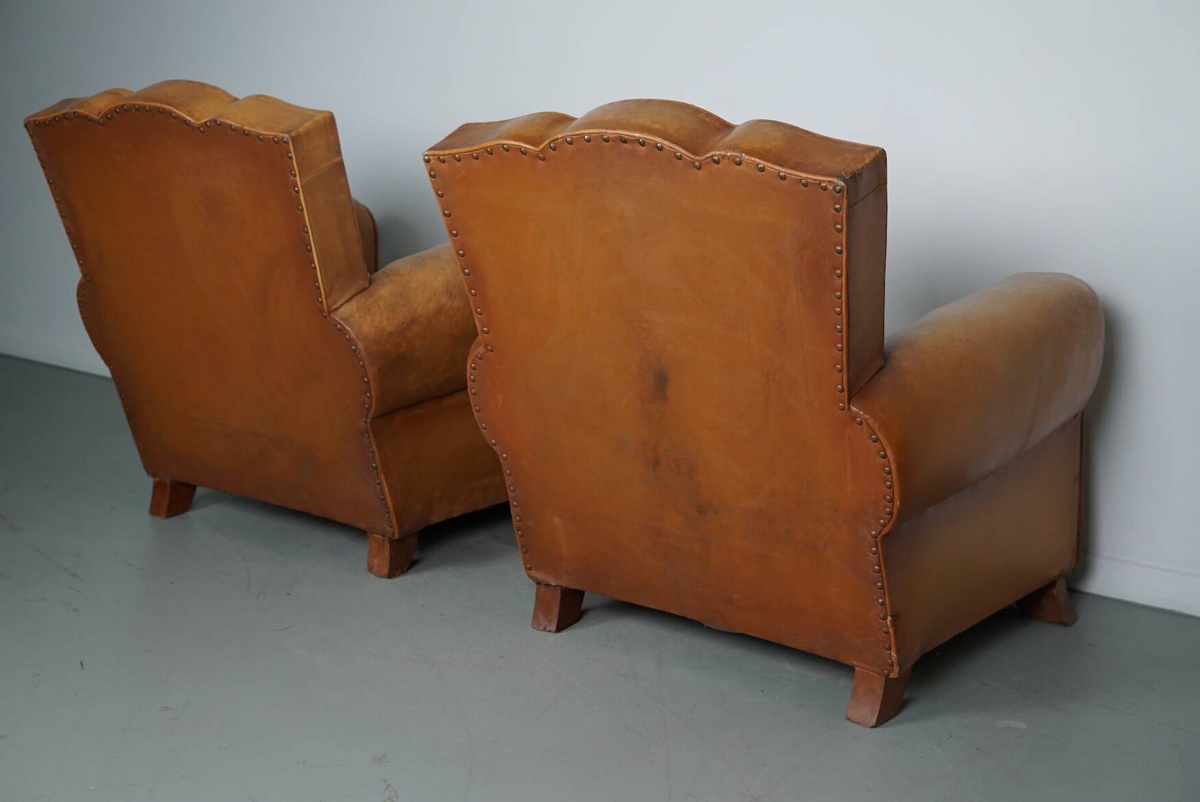 Pair of French Cognac Moustache Back Leather Club Chairs, 1950s