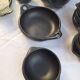 Black terracotta dinnerware set from La Chamba in Colombia. Set of 13 pieces.