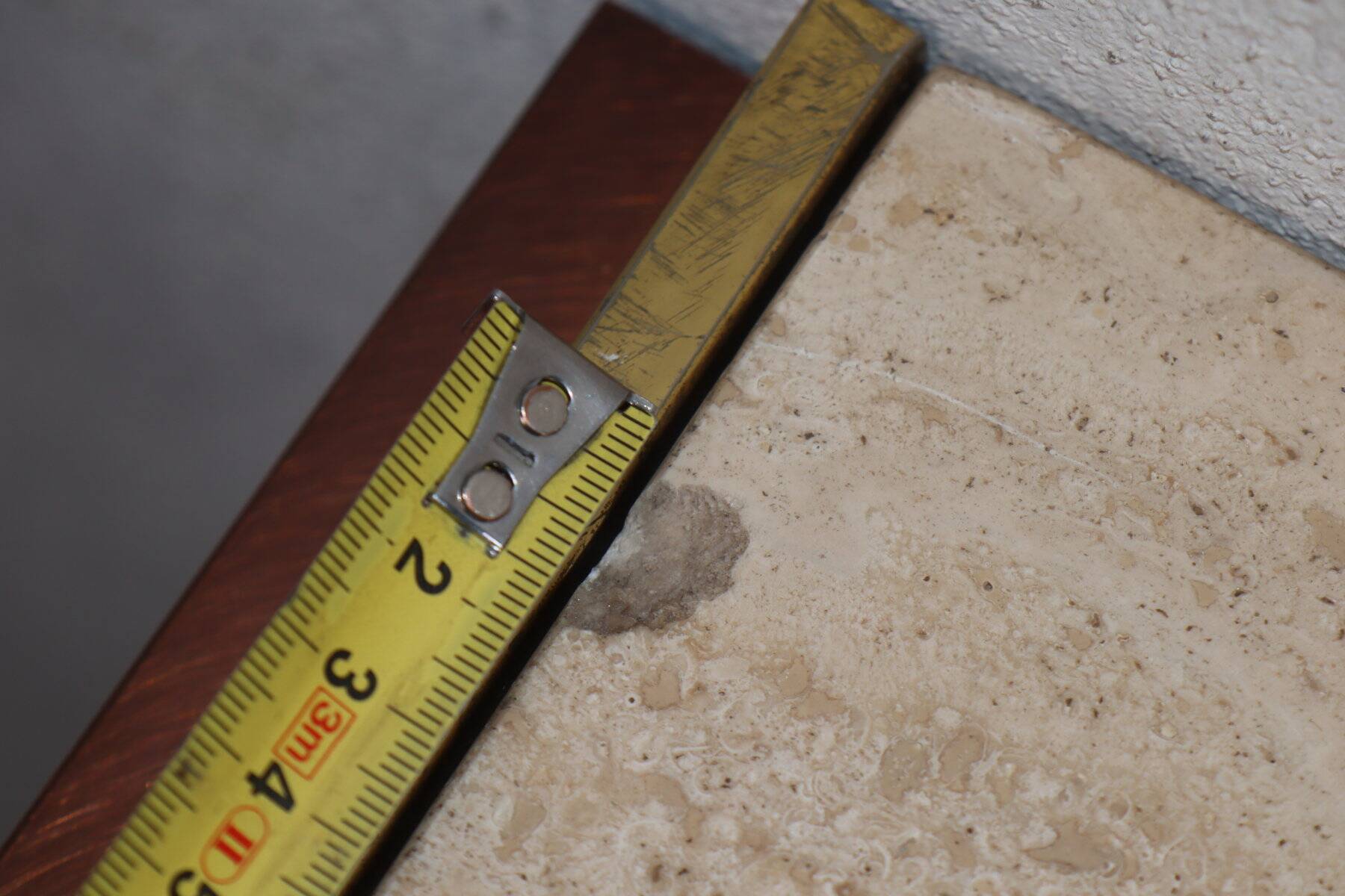Minimalist console in travertine and patinated metal — 1970s