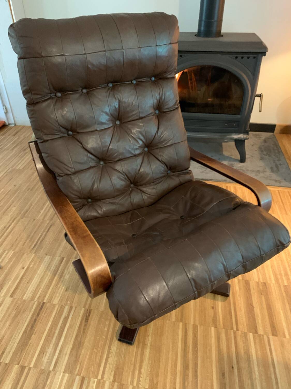 Vintage leather armchair with wooden armrests