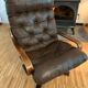 Vintage leather armchair with wooden armrests