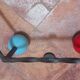 Vintage wall coat rack "Atomic" in wrought iron with multicoloured balls.