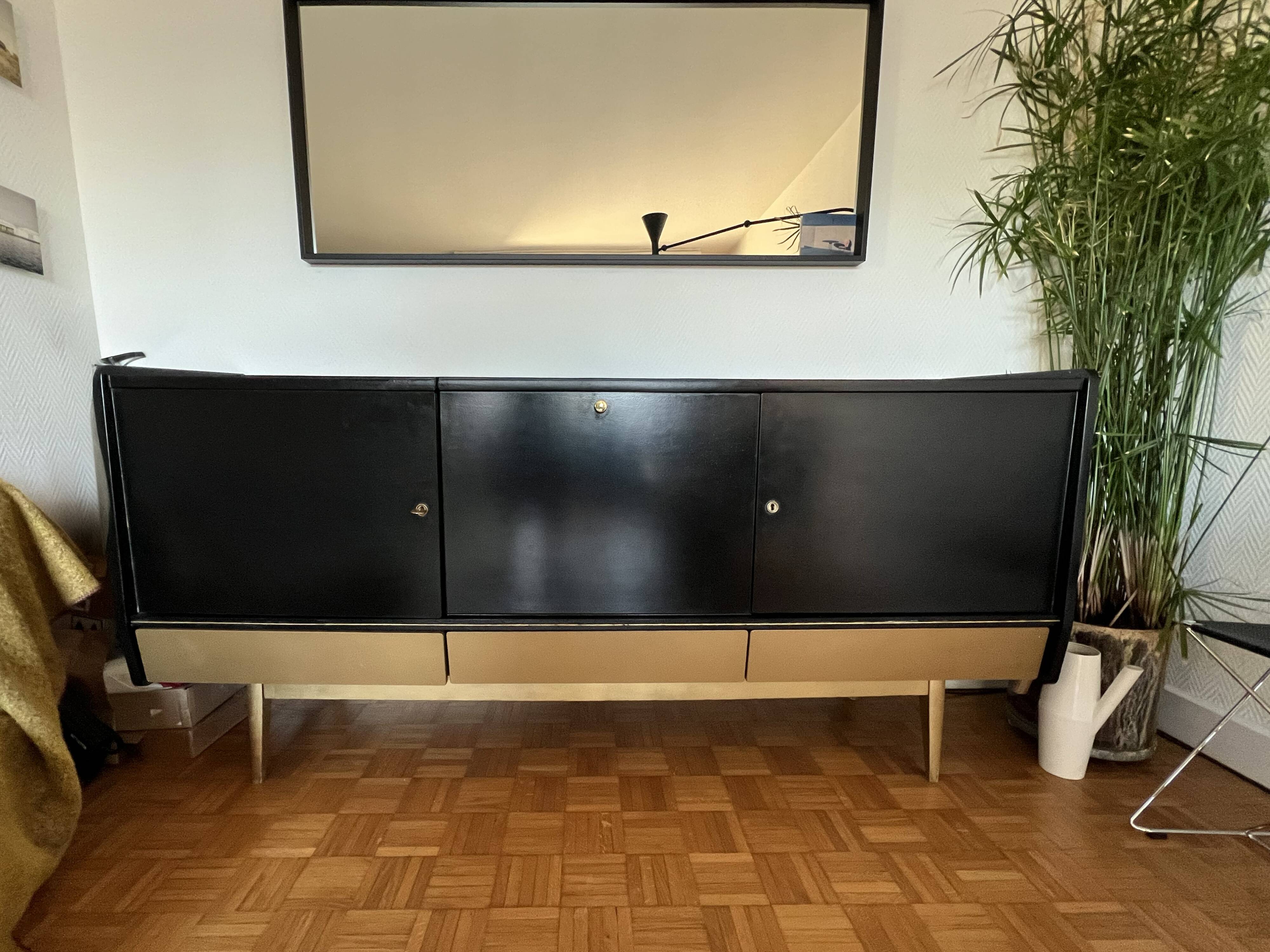 Black buffet cabinet including a bar and 3 drawers.