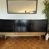 Black buffet cabinet including a bar and 3 drawers.