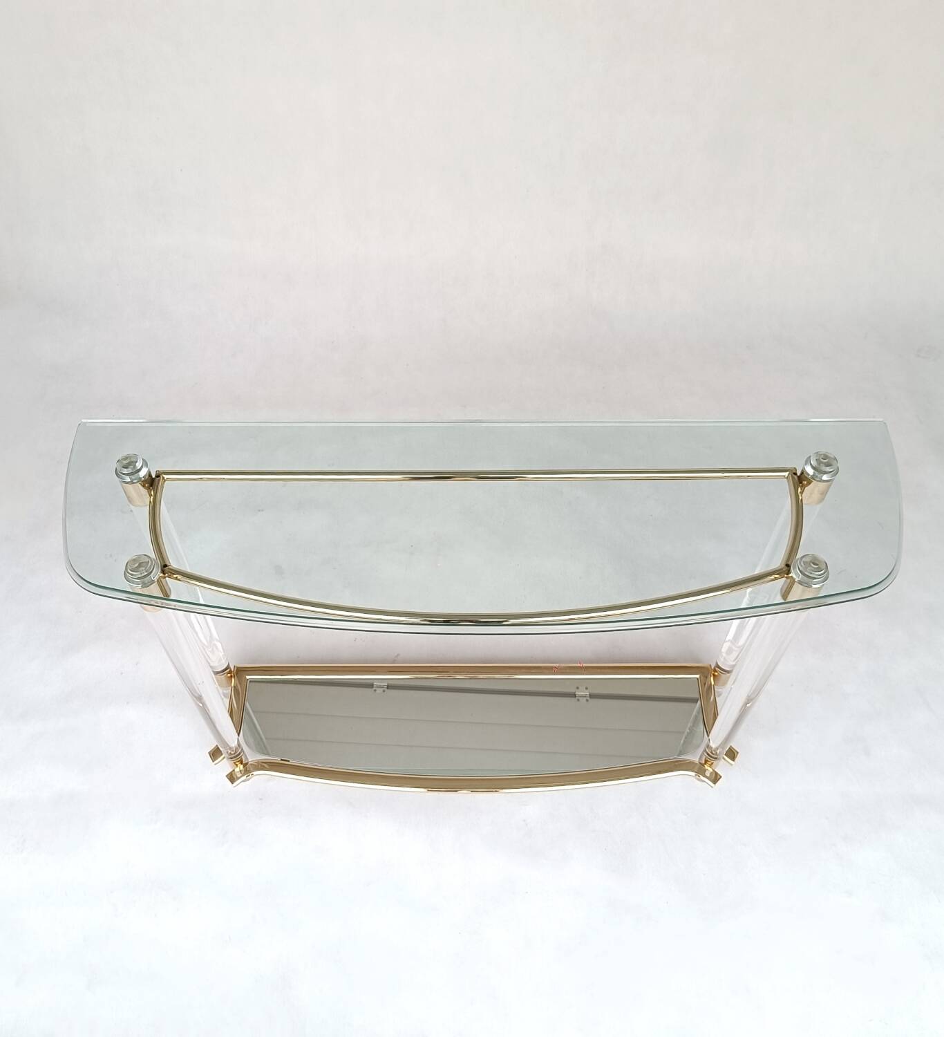 Hollywood Regency console table in lucite, glass and gold metal. 1980s
