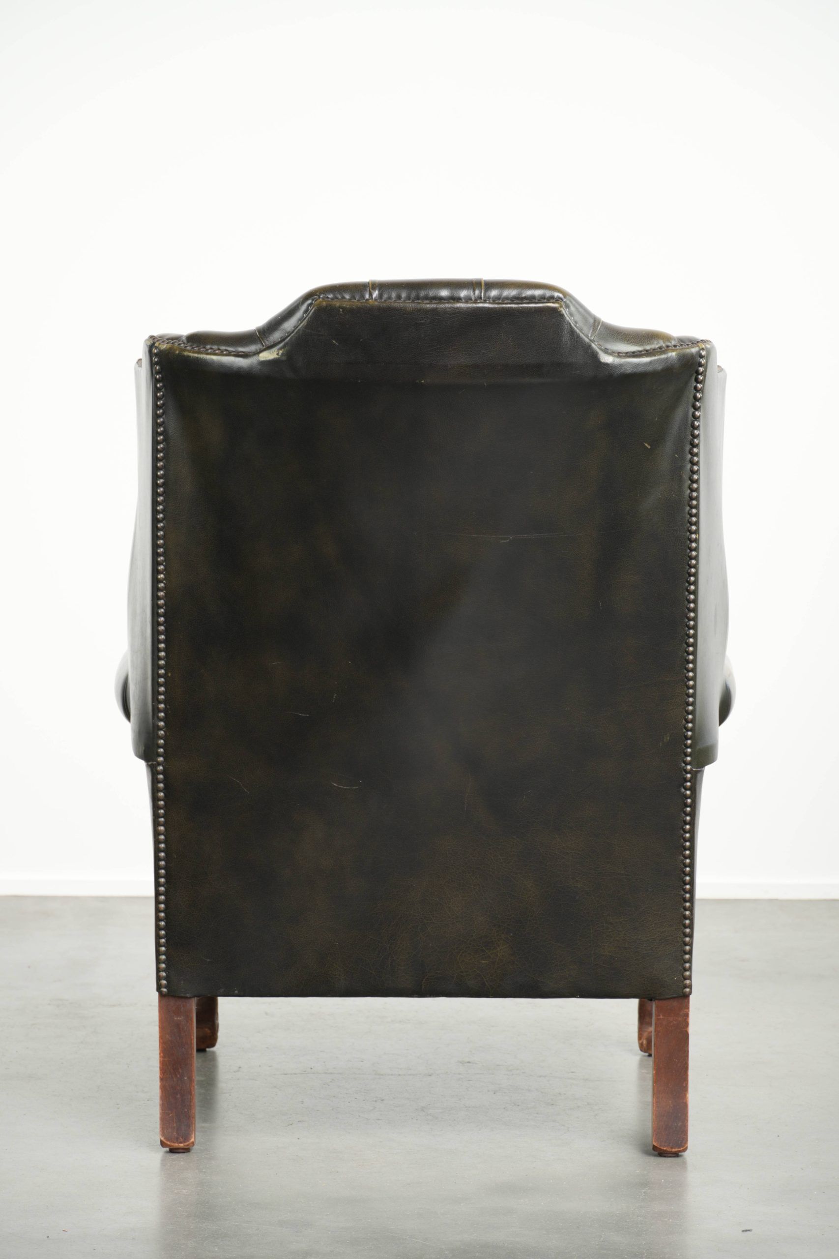 Vintage cowhide leather Chesterfield wingback armchair in a green colour