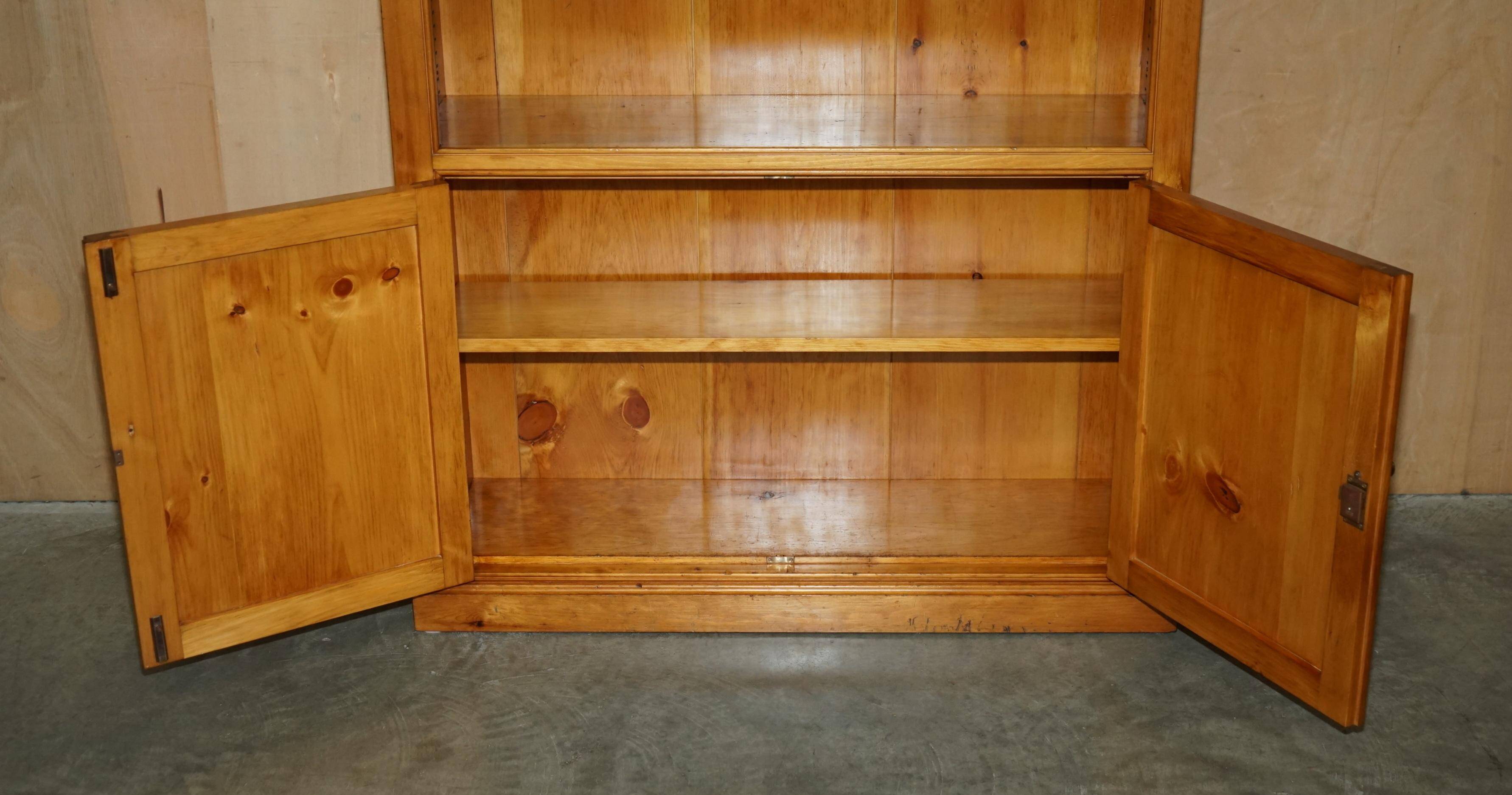 Pair of vintage cherry wood bookcases with lockable doors.