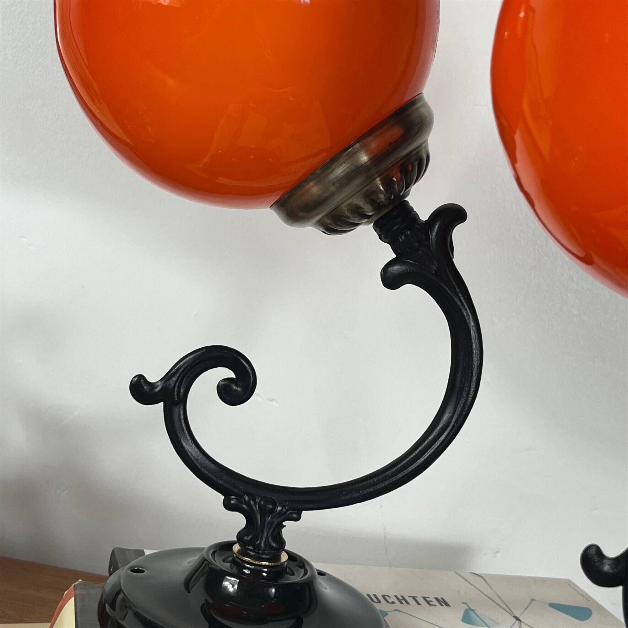 Pair of wall sconces with orange opaline globes and porcelain rose.