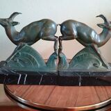 Pair - Chamois metal bookends with green patina & black marble base