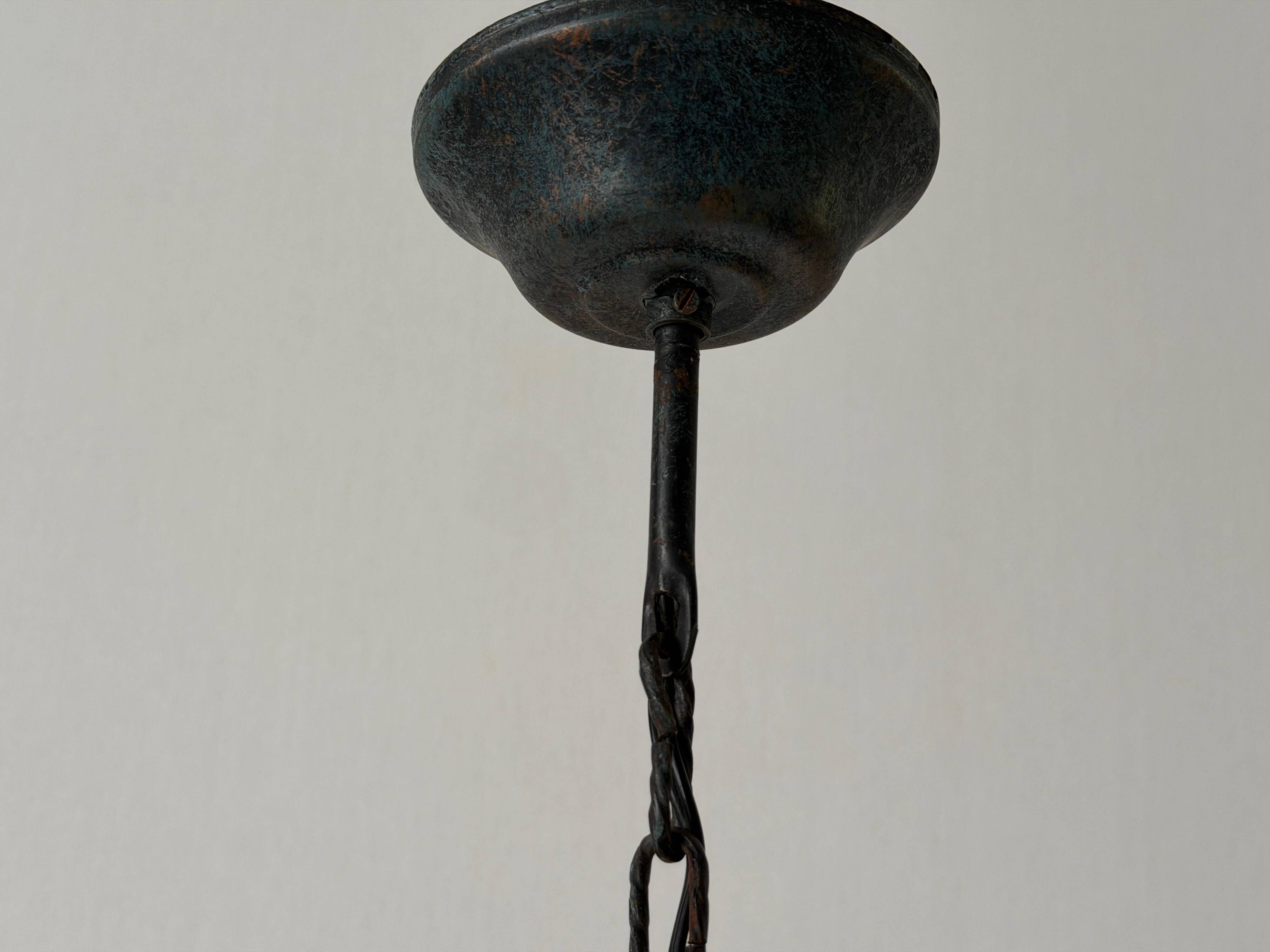 Three-armed suspended lamp in wrought iron, brutalist design, 1960s, Italy.