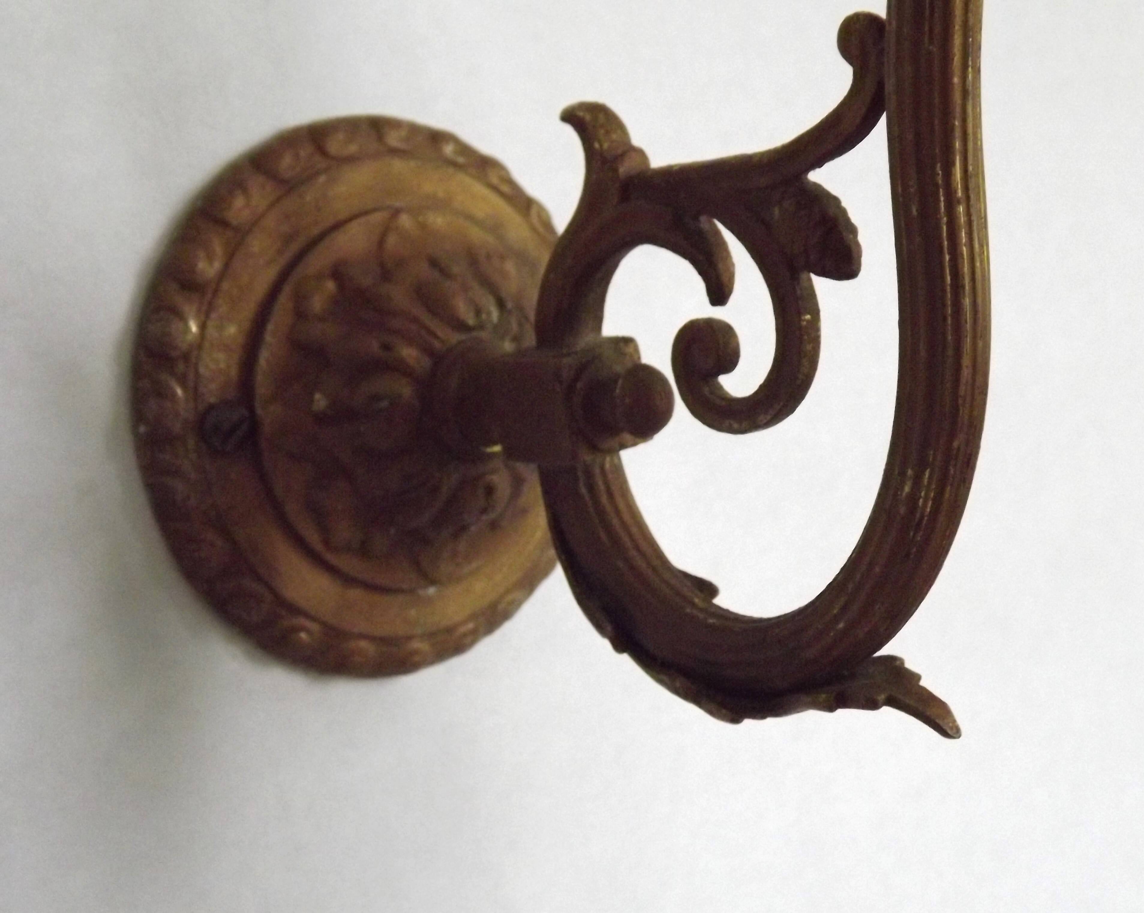 French Art Nouveau wall sconce in bronze with a white and pink glass shade.