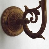 French Art Nouveau wall sconce in bronze with a white and pink glass shade.