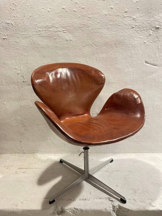 First edition Arne Jacobsen Swan chair, original patinated leather, 1950s