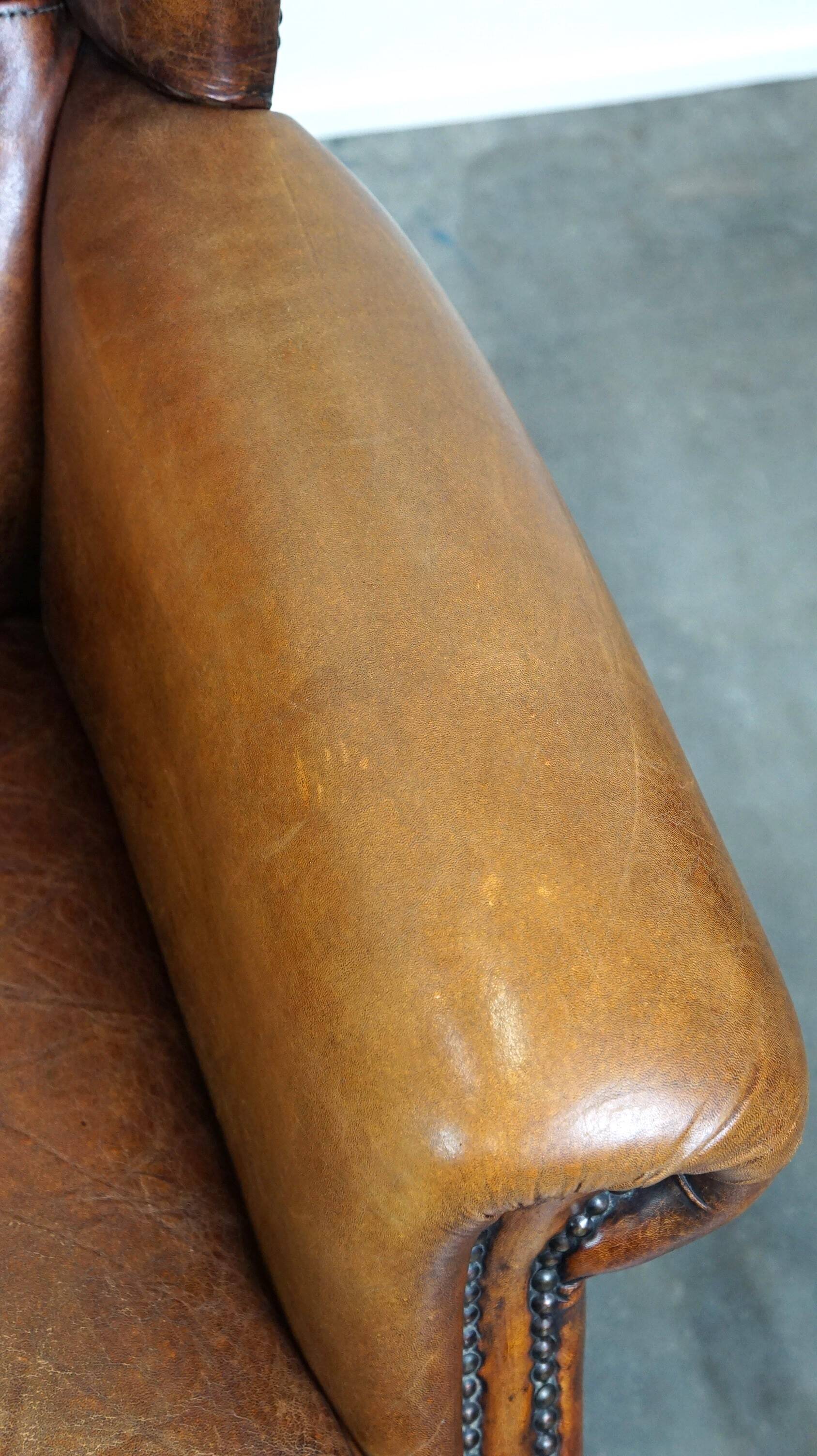 Set of 2 beautiful and correct sheep leather wingback armchairs with fixed seat cushions