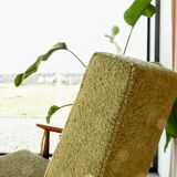 Mid-century modern armchair in olive green bouclé design by H. Lis.