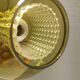 Hanging lamp with an outer shade of olive green glass and an inner shade of clear, crystal glass.