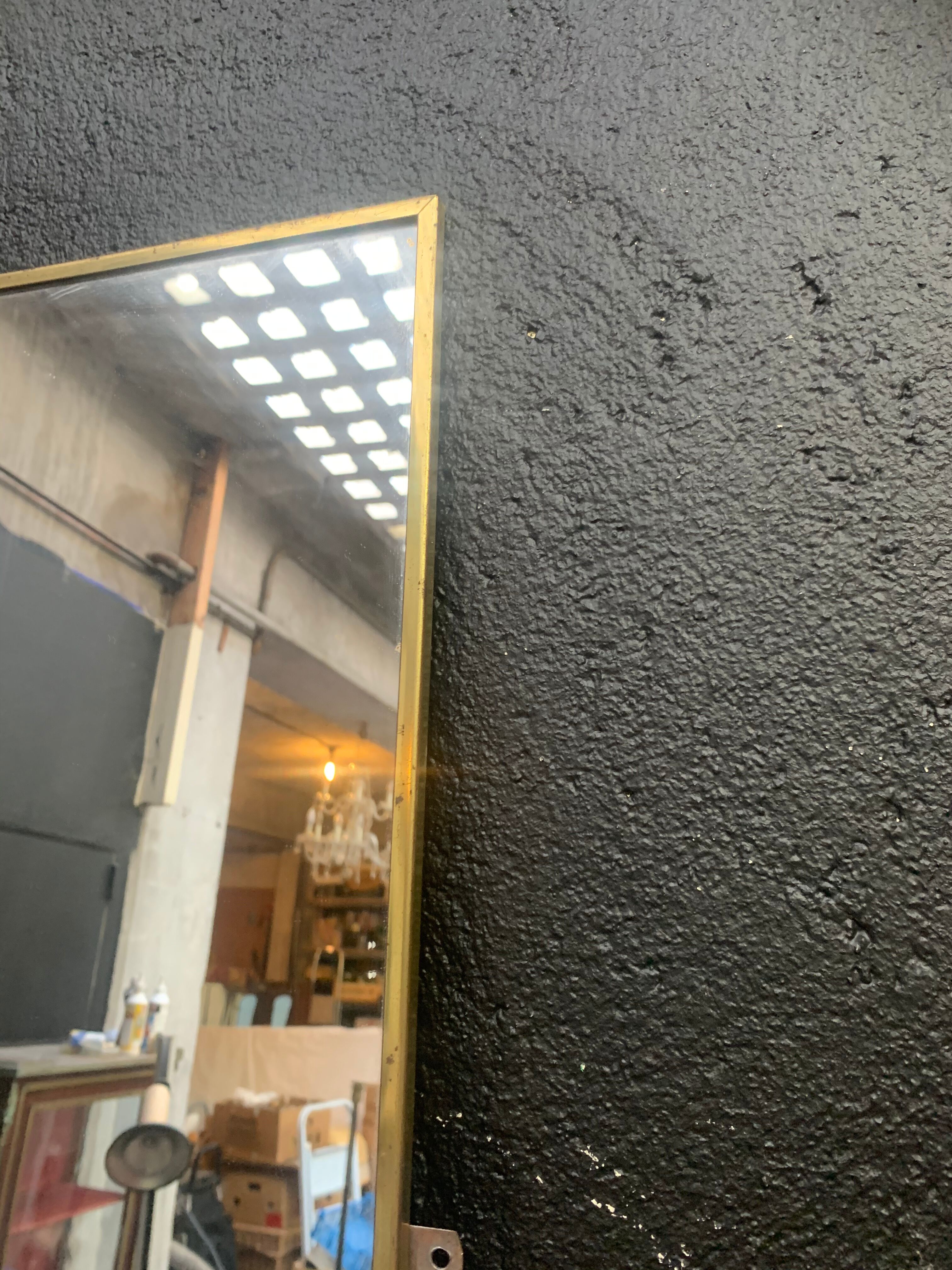 Mirror of two, narrow glass in gold metal 1950