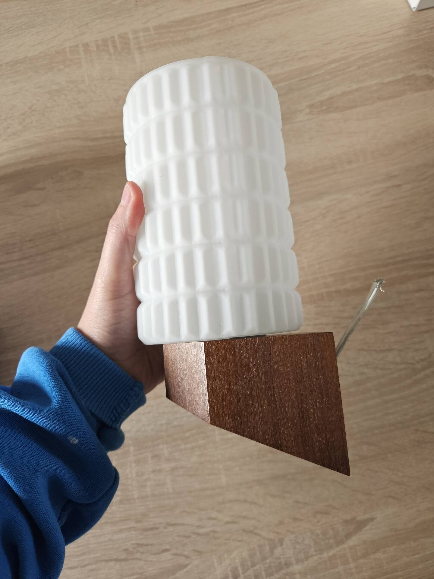 Philips wall sconces in wood and white opal.