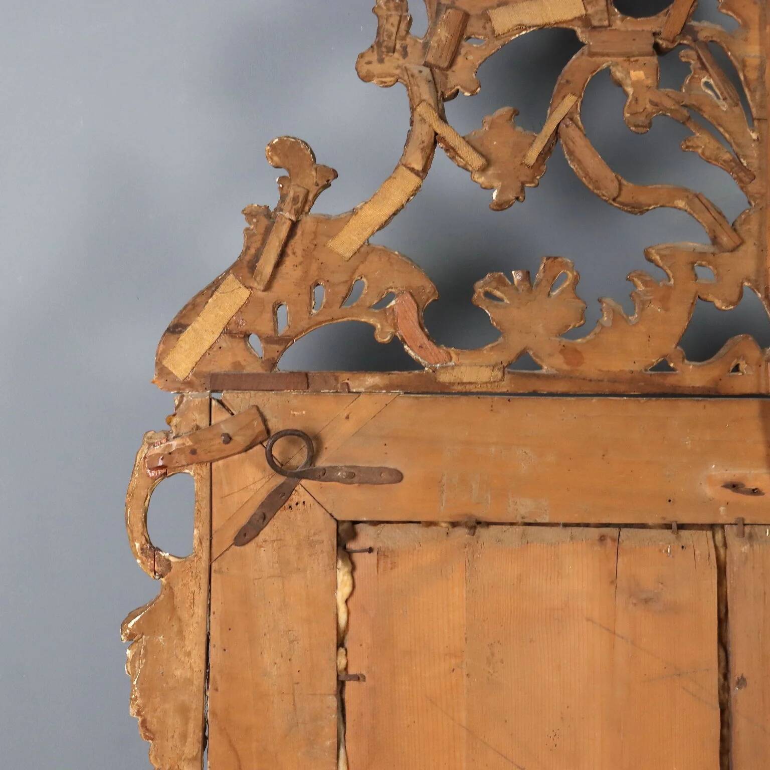 Antique gilded wooden mirror with rococo patterns, Italy, 18th century.