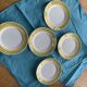 6 small plates with yellow borders and floral pattern gold antiques