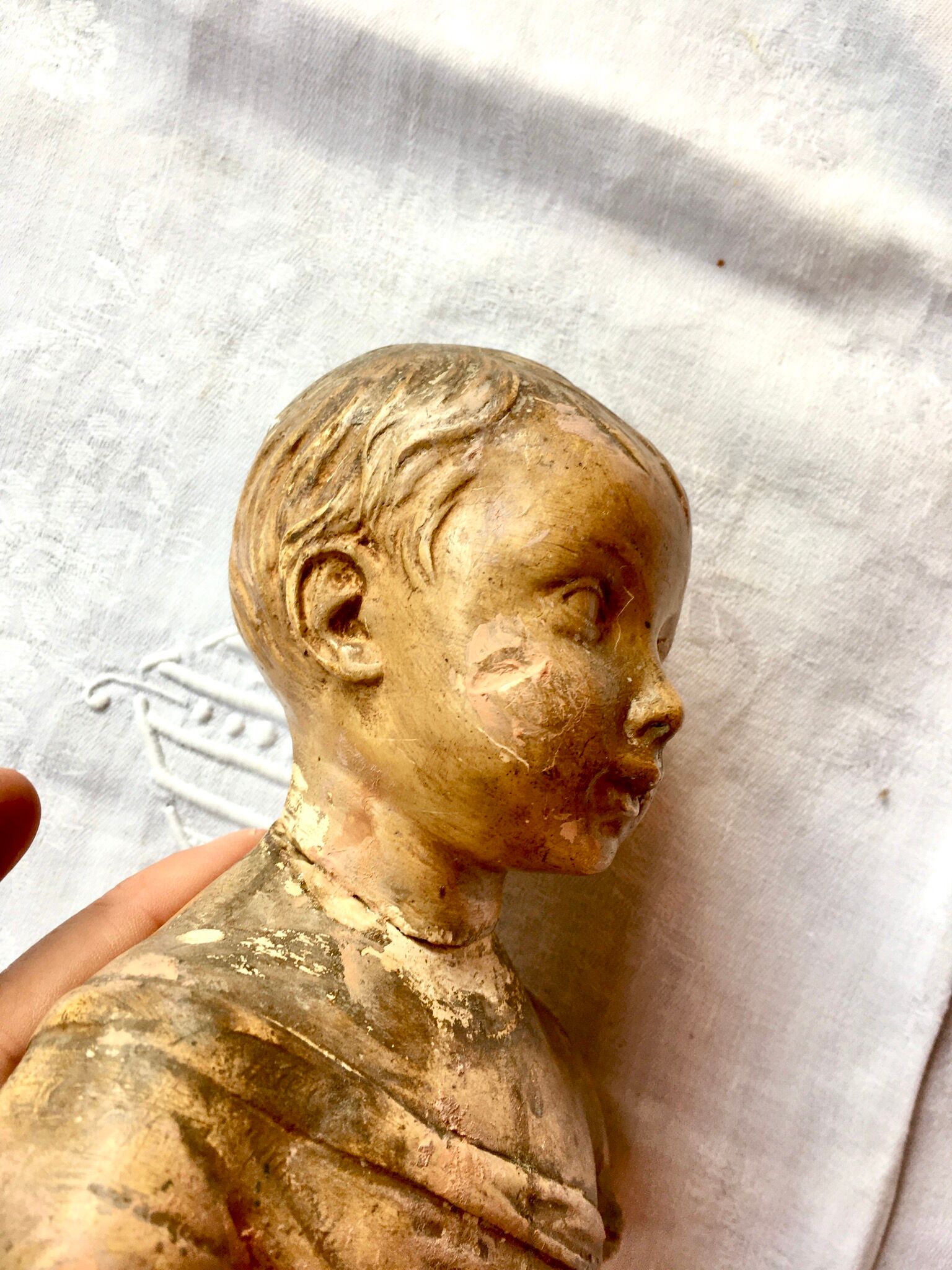 Carved earth bust