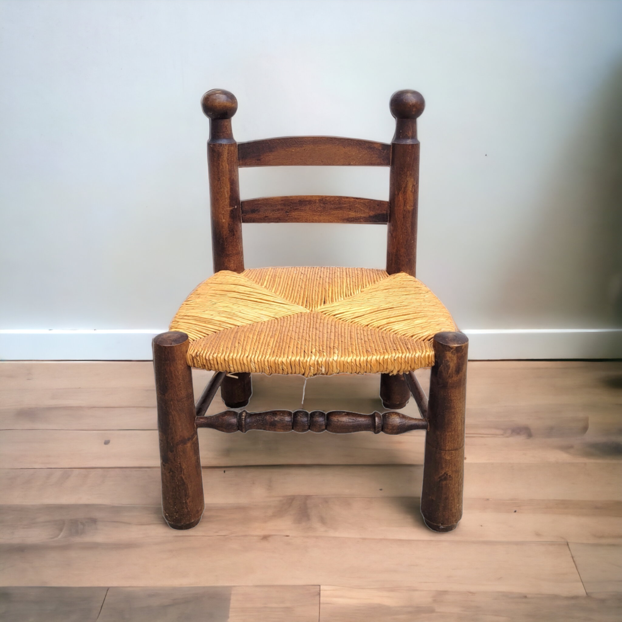 Low chair in turned wood and straw
