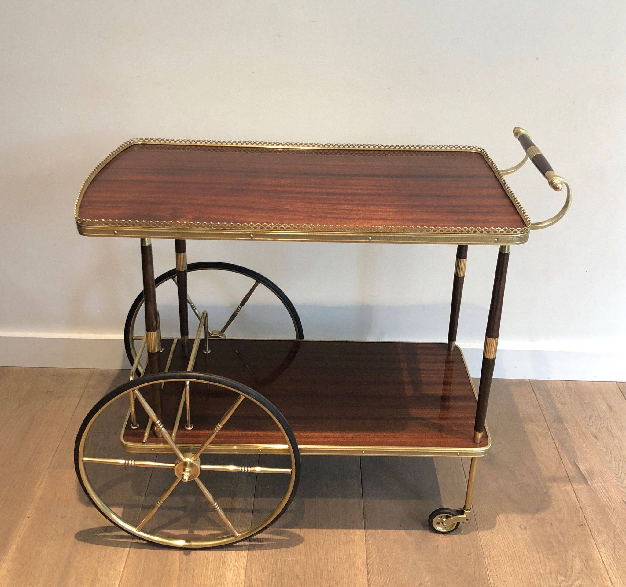 Mahogany and brass rolling table in the style of Maison Jansen.